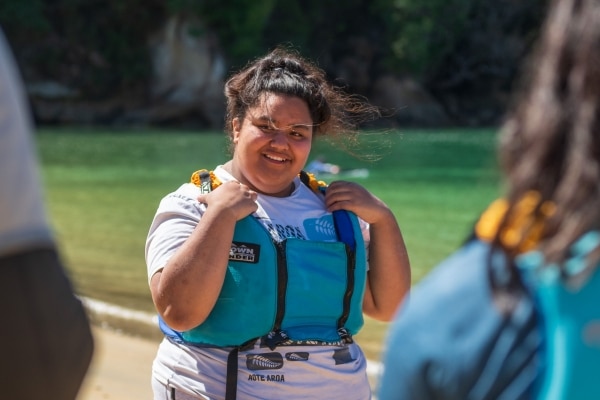 Secondary school student smiling in a life jacket