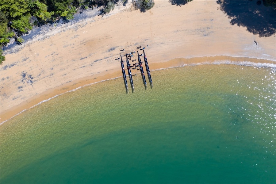 two double hulled waka on the beach (photo taken from above)